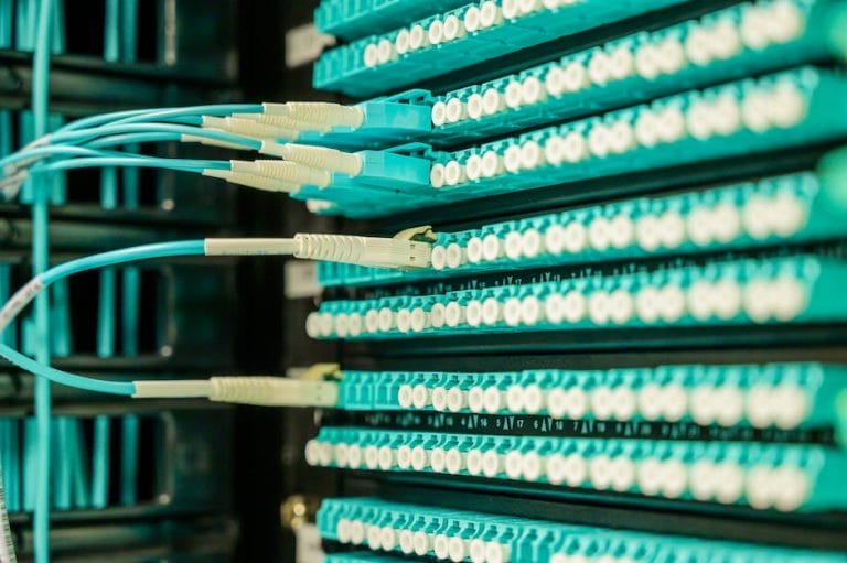 A rack of blue wires in a data center.